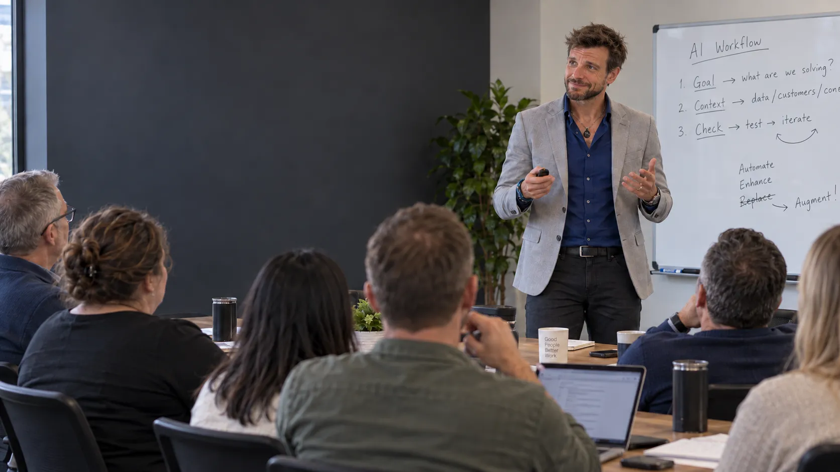 Pete teaching an AI workshop to colleagues in an office conference room