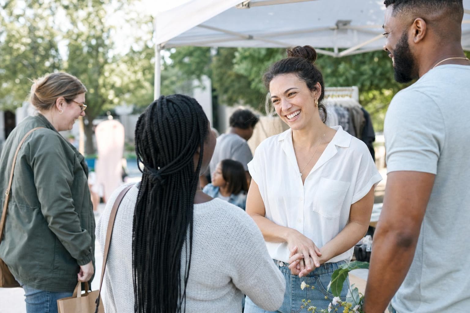 A photo of a community-focused local business owner connecting with neighbors at a town event.