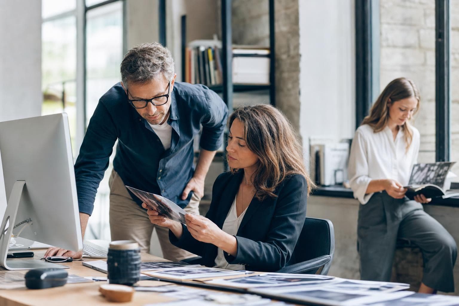 A photo of a split scene showing an authentic real-workplace image being chosen over a generic stock photo.
