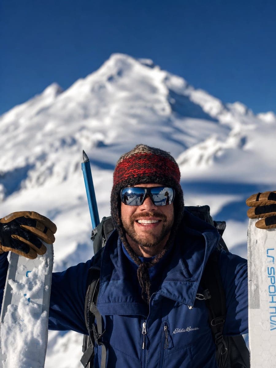 Pete backcountry skiing on a snowy summit