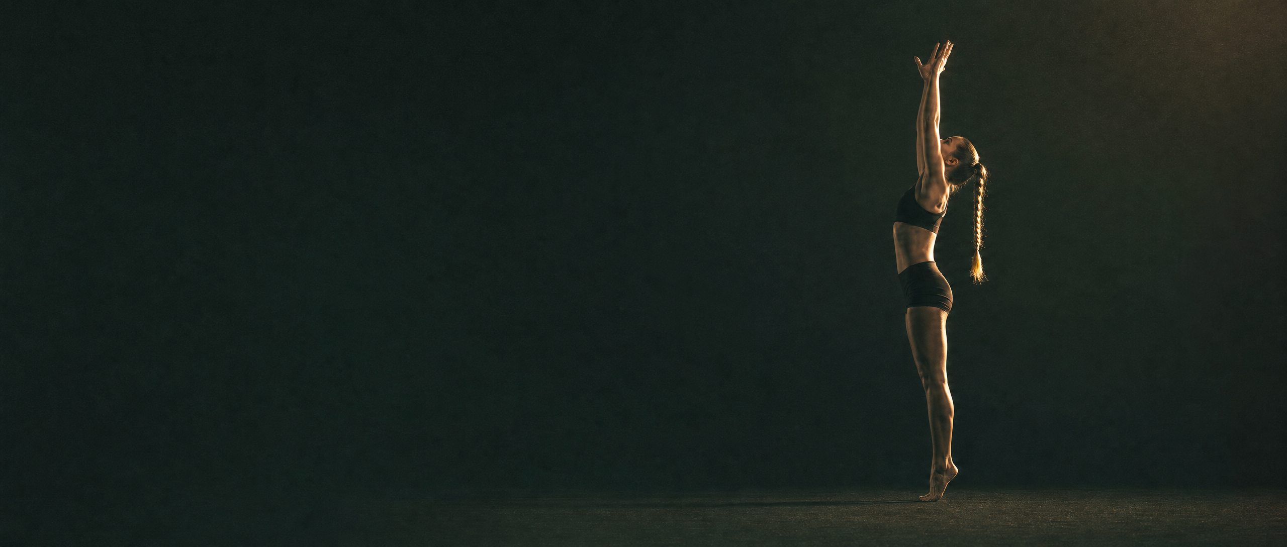 An athlete reaching upward through a controlled range