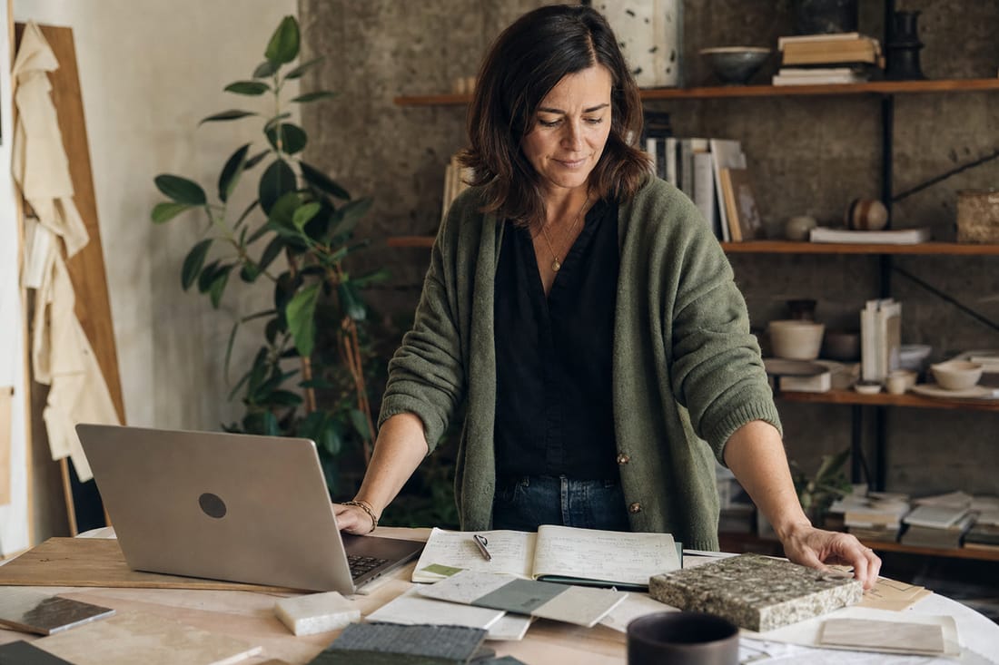 A founder reviewing material samples in her studio