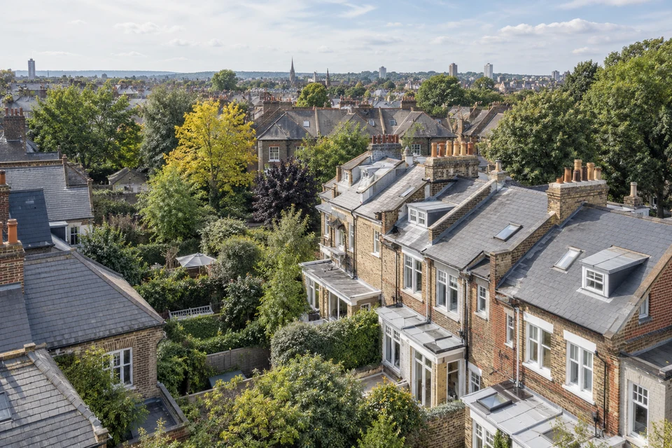 An oblique aerial view across varied residential rooftops.